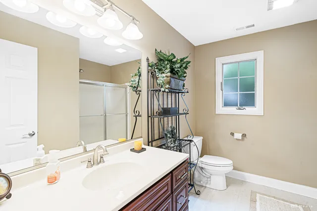 a bathroom with a sink a toilet and a mirror