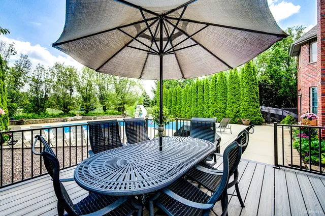 a view of a patio with a table chairs and a umbrella