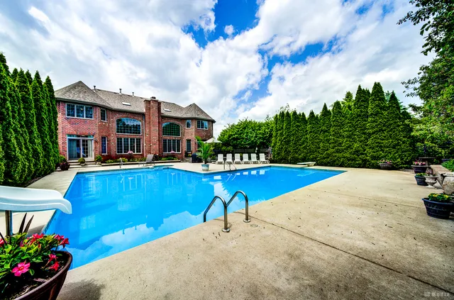 a view of a swimming pool with a lounge chairs