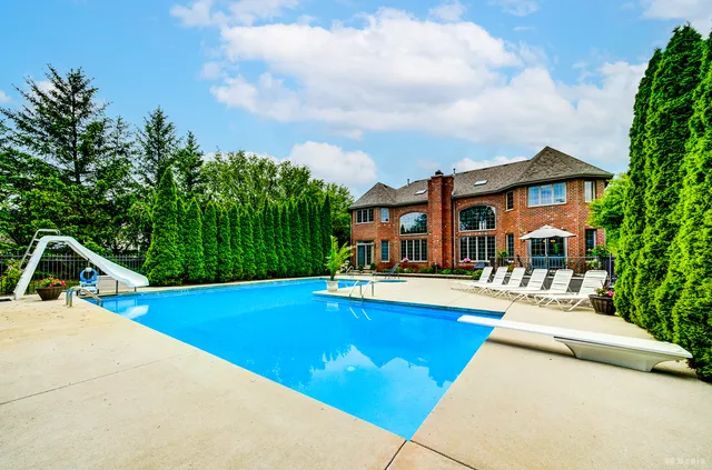 a view of a house with swimming pool and porch