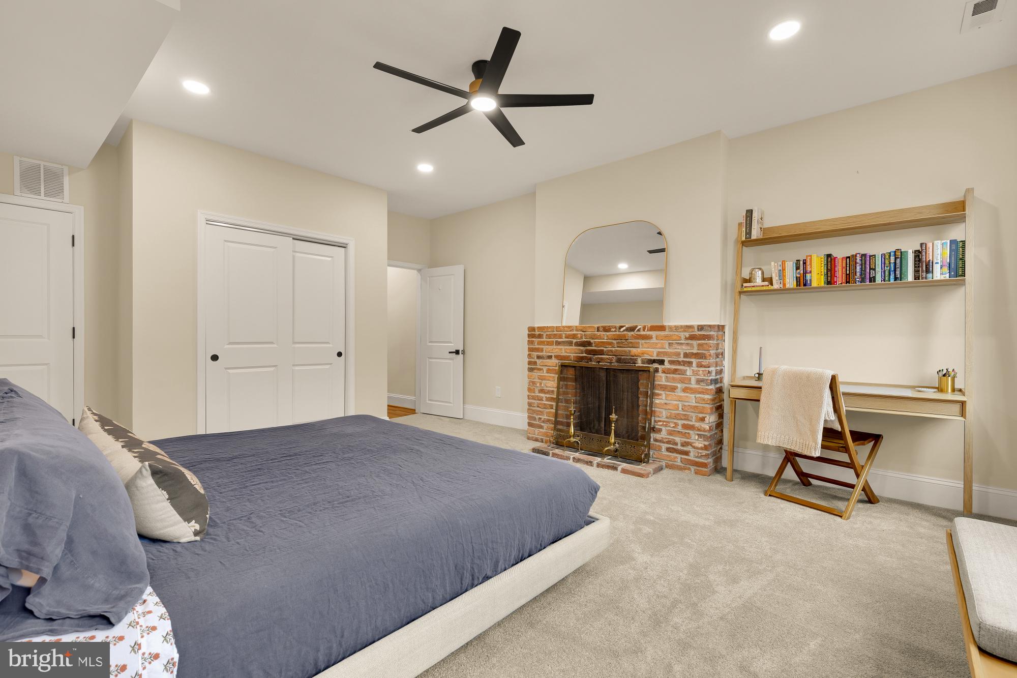 2208 East Baltimore Street Baltimore, MD 21231 - Photo 20 of 46 a spacious bedroom with a bed and a fireplace