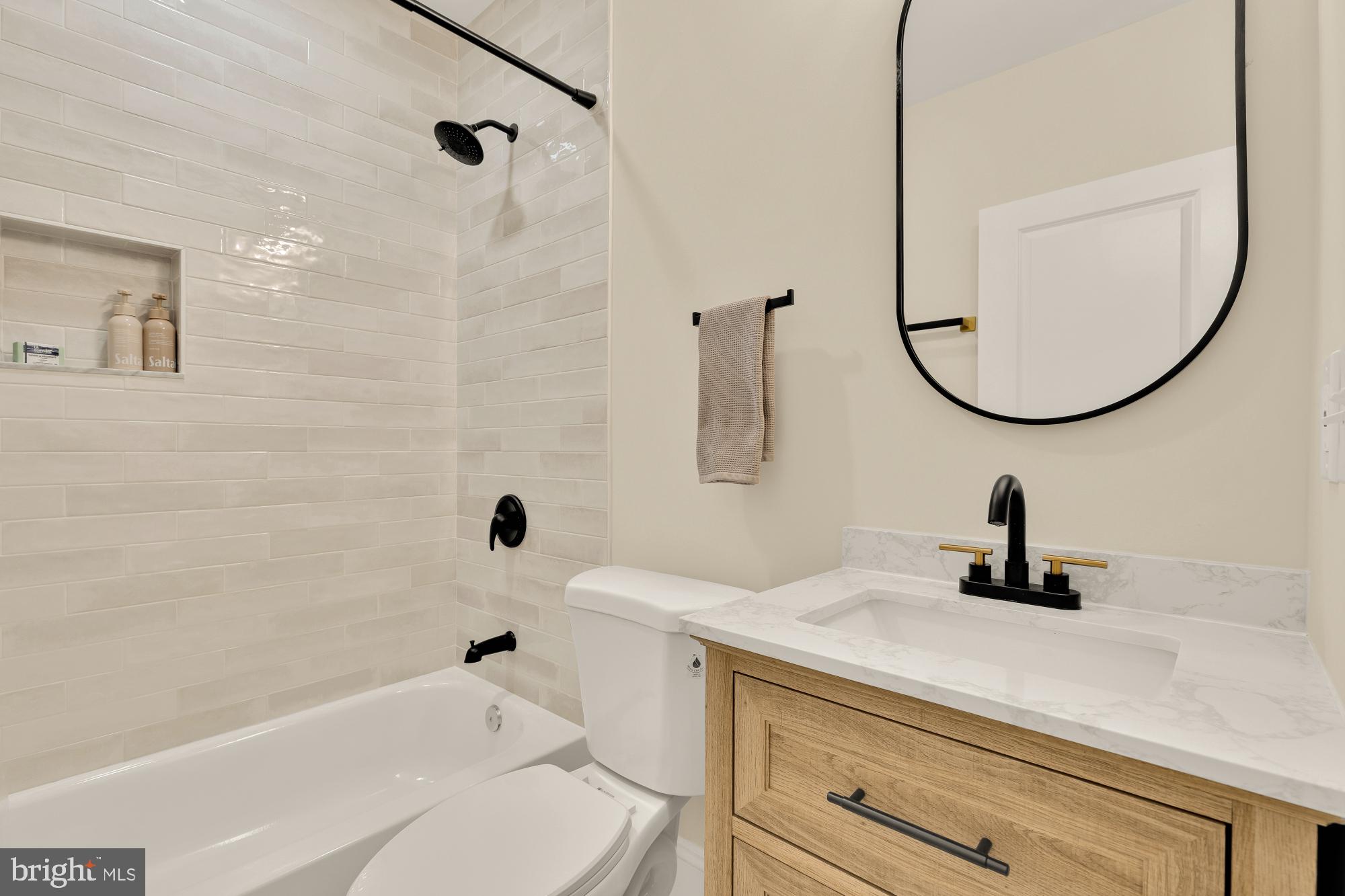 2208 East Baltimore Street Baltimore, MD 21231 - Photo 21 of 46 a bathroom with a sink a toilet and a mirror