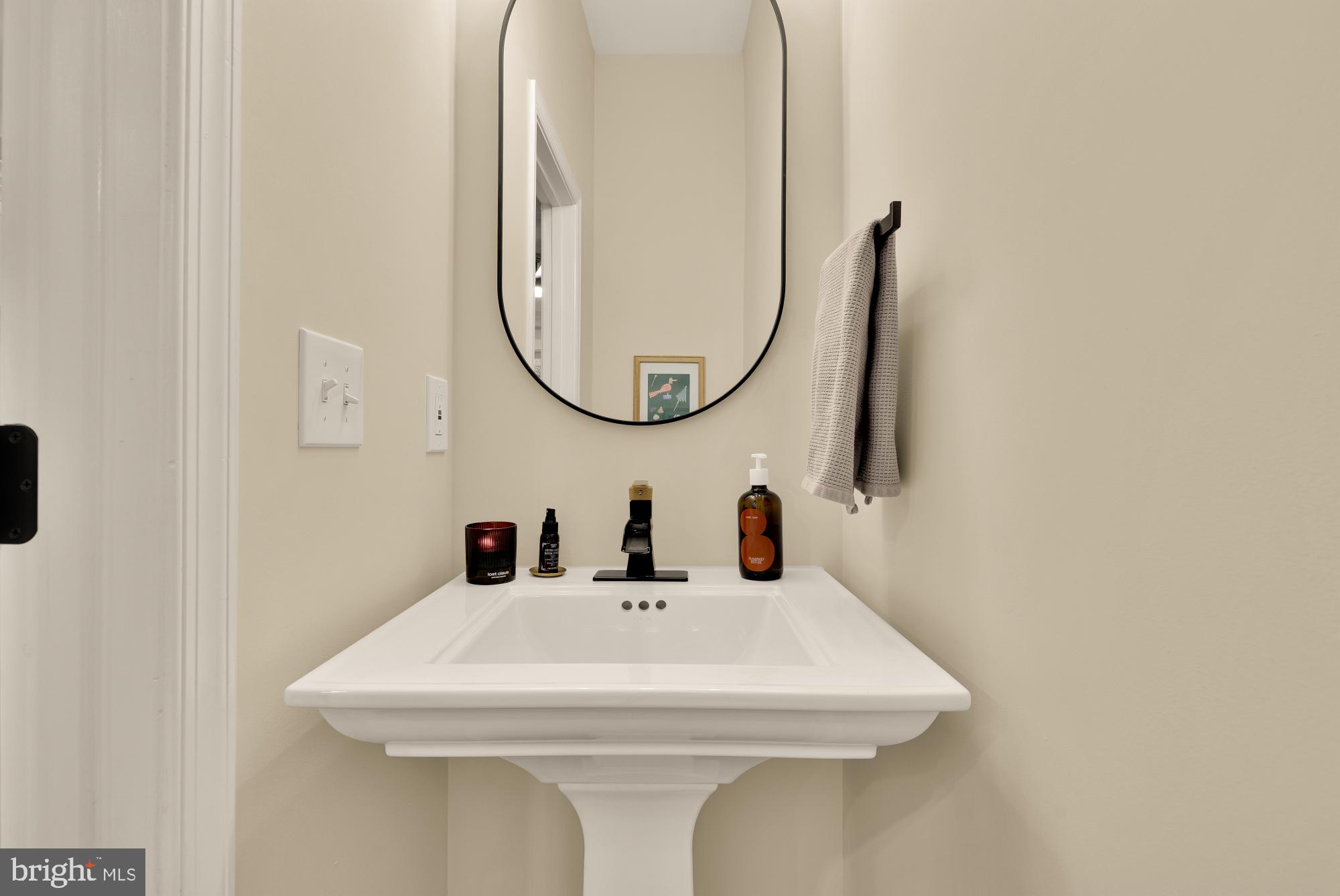 2208 East Baltimore Street Baltimore, MD 21231 - Photo 7 of 46 a bathroom with a sink and a mirror