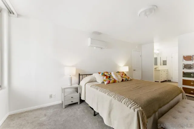 a bed room with a bed and a night stand