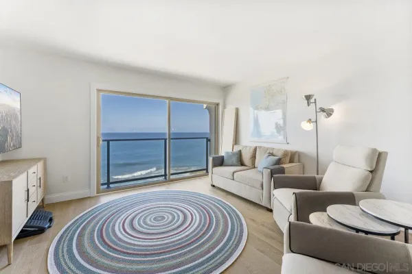a living room with furniture and a floor to ceiling window