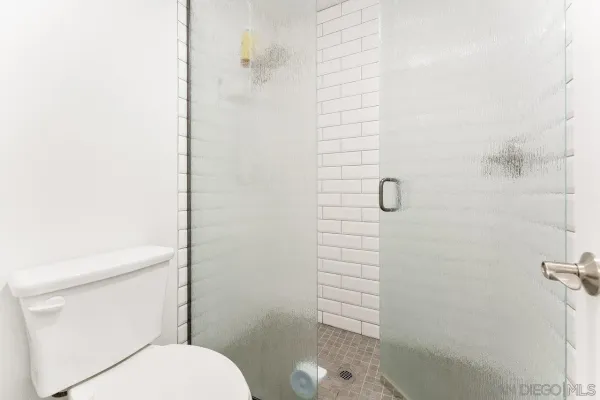 a bathroom with a toilet and shower