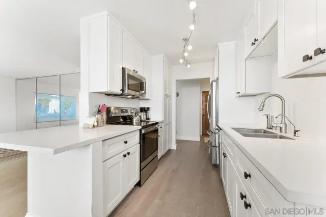 a kitchen with stainless steel appliances granite countertop a sink and cabinets
