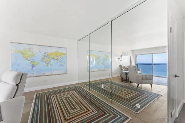 a spacious bathroom with a glass door shower and a rug