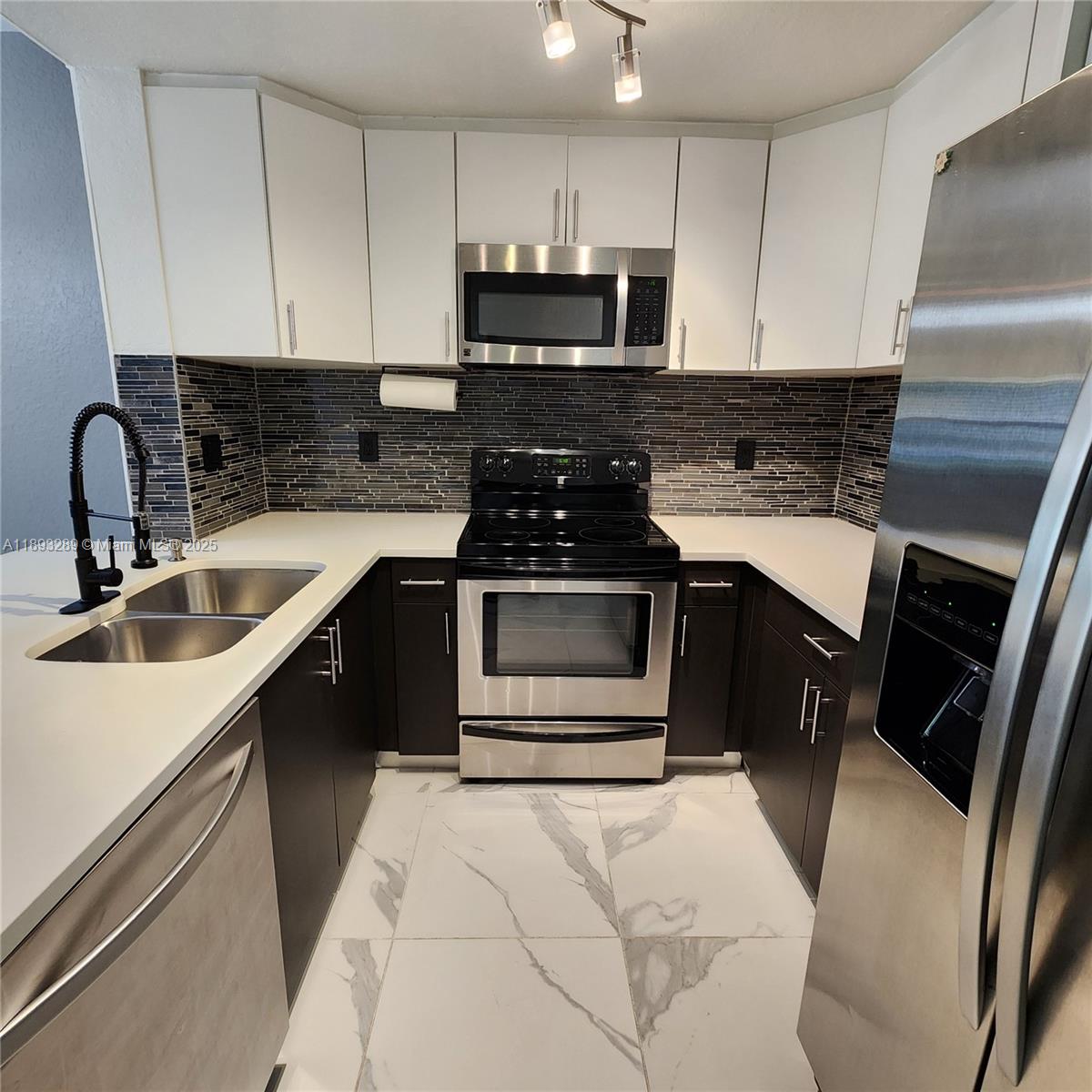 2941 Riverside Drive, Unit 102 Coral Springs, FL 33065 - Photo 1 of 37 a kitchen with a sink stove and cabinets