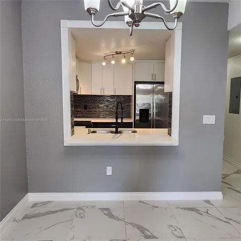 a view of a bathroom with a sink and mirror