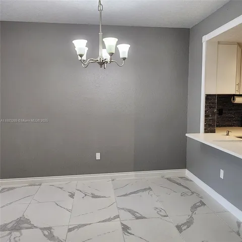 a view of a kitchen with a sink and dishwasher