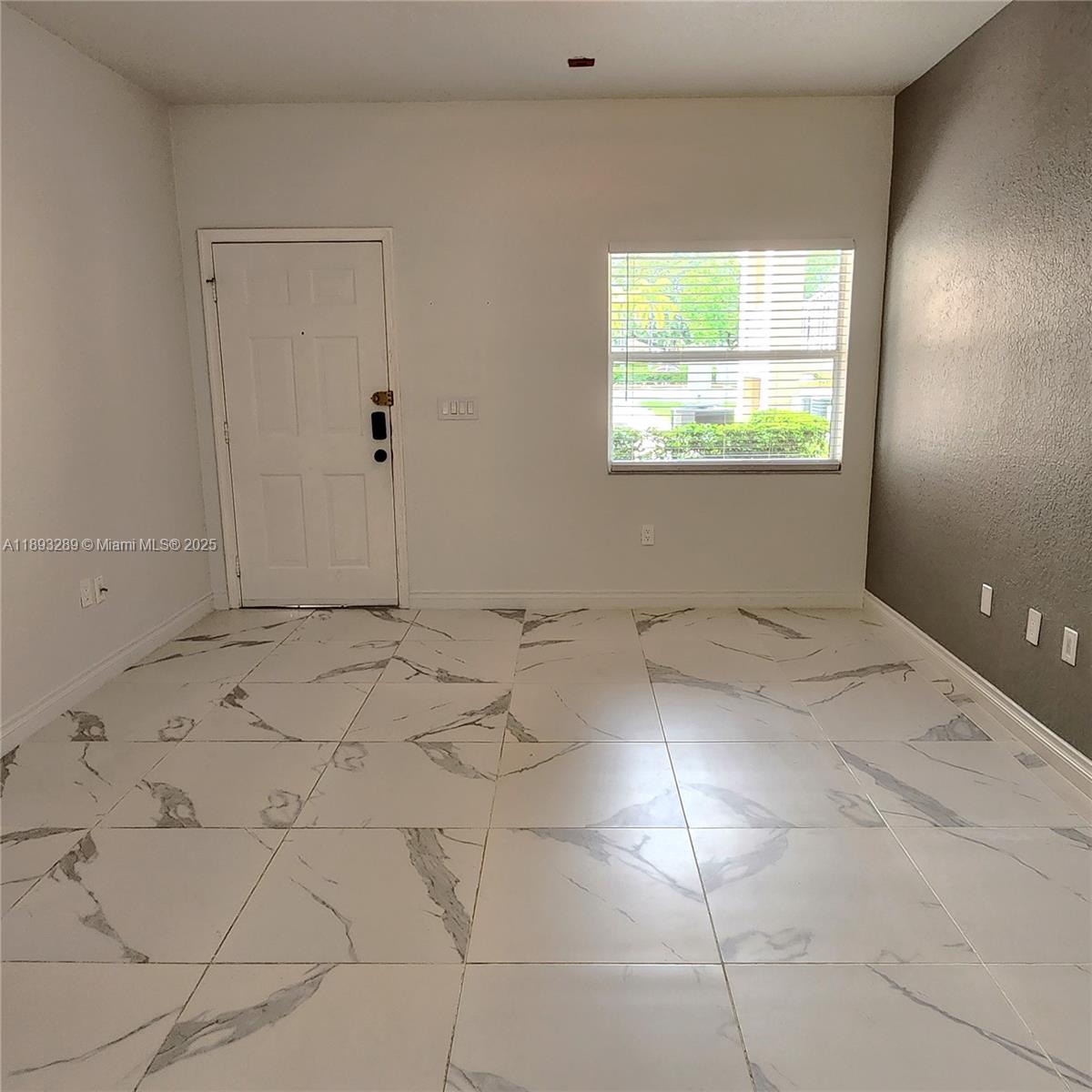 2941 Riverside Drive, Unit 102 Coral Springs, FL 33065 - Photo 14 of 37 a view of an empty room with a window