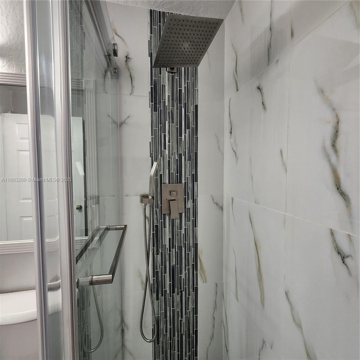 2941 Riverside Drive, Unit 102 Coral Springs, FL 33065 - Photo 16 of 37 a bathroom with a shower