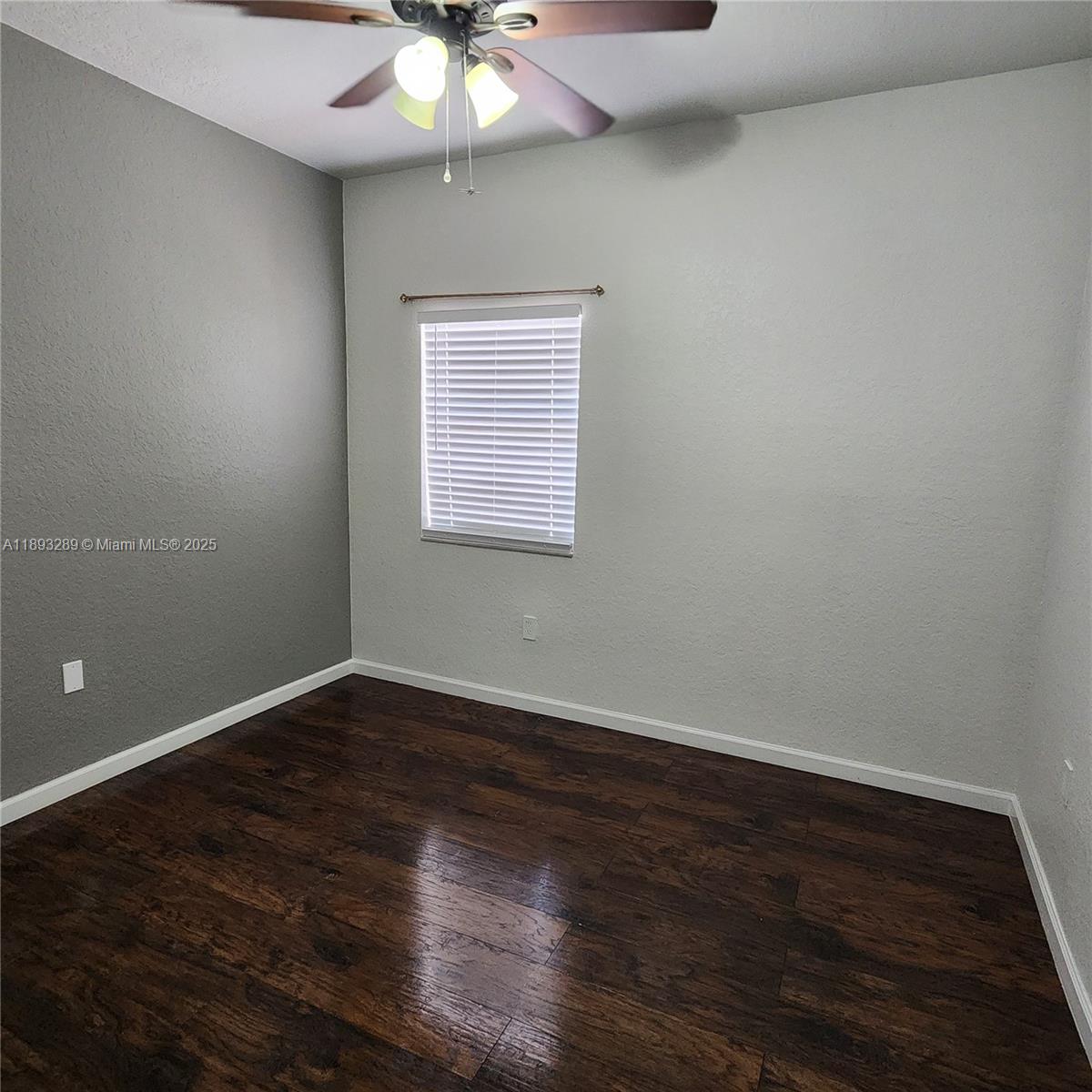 2941 Riverside Drive, Unit 102 Coral Springs, FL 33065 - Photo 20 of 37 an empty room with wooden floor and windows