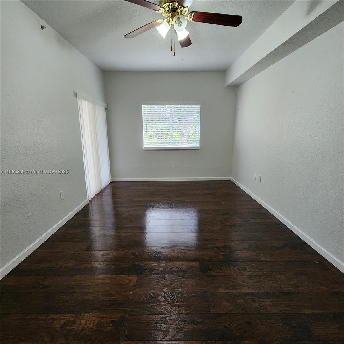 2941 Riverside Drive, Unit 102 Coral Springs, FL 33065 - Photo 24 of 37 a view of an empty room with wooden floor and a window