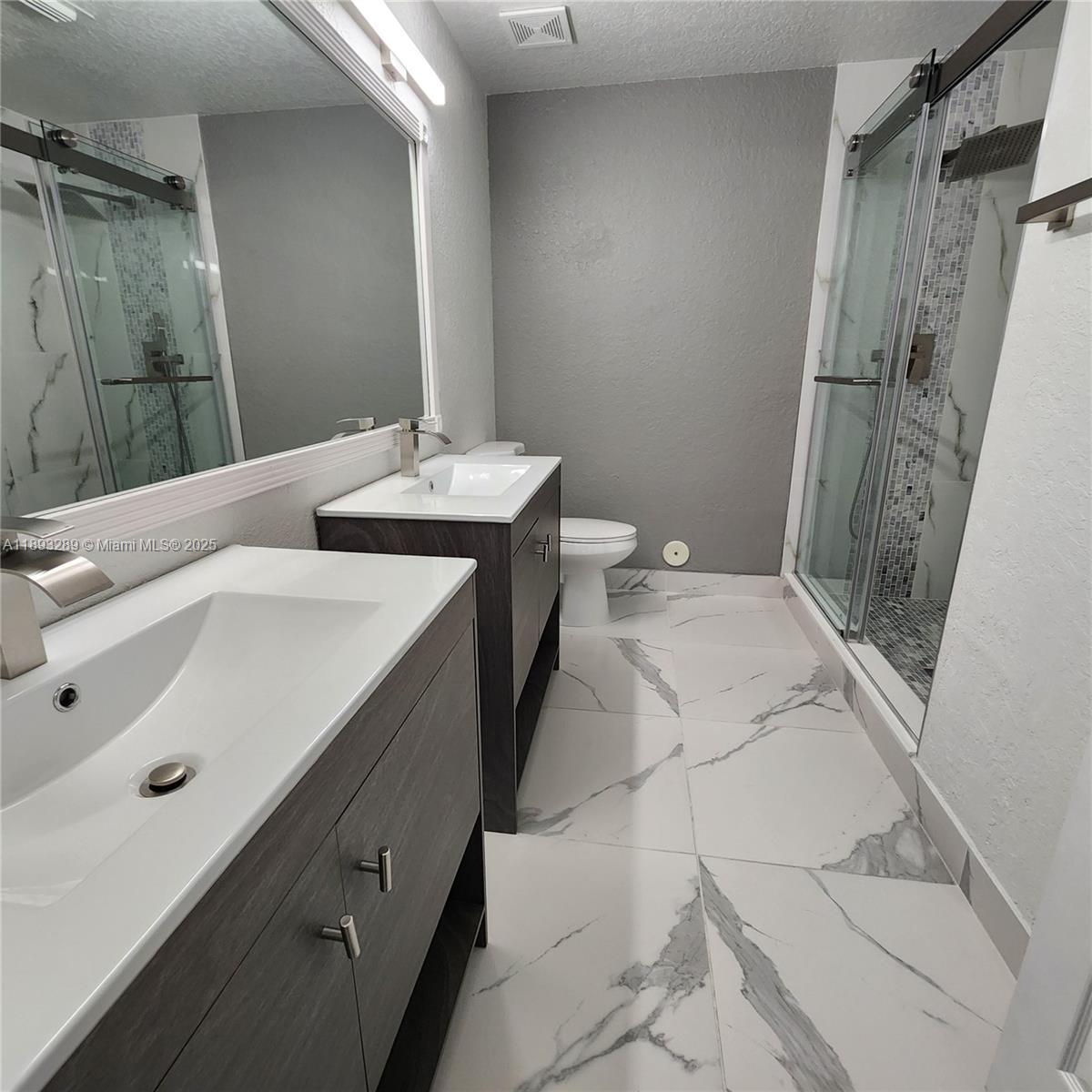 2941 Riverside Drive, Unit 102 Coral Springs, FL 33065 - Photo 26 of 37 a bathroom with a sink and mirror