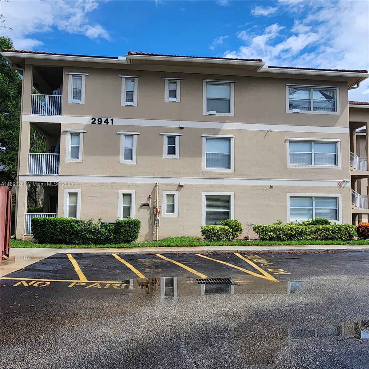 2941 Riverside Drive, Unit 102 Coral Springs, FL 33065 - Photo 3 of 37 a front view of a house with garden