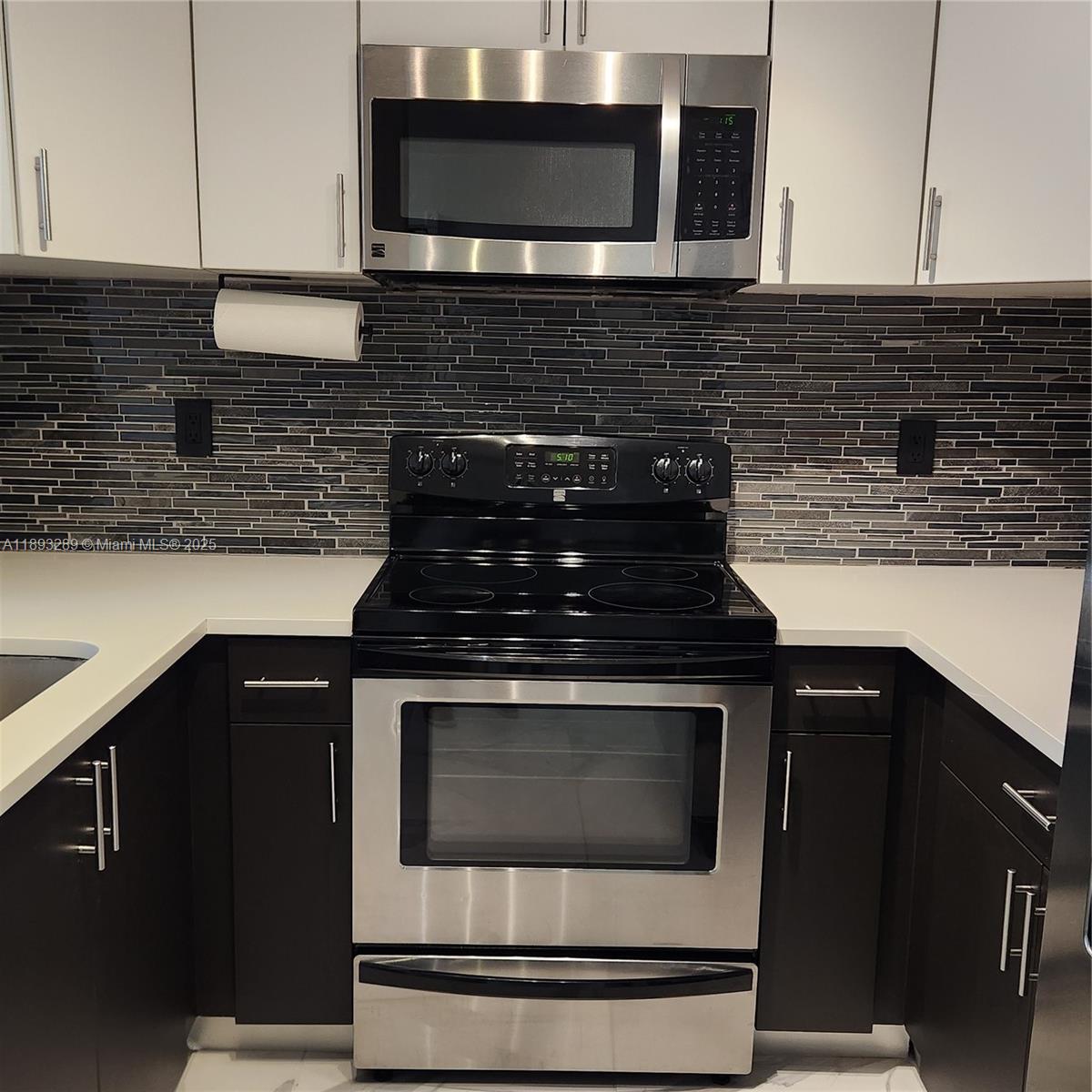 2941 Riverside Drive, Unit 102 Coral Springs, FL 33065 - Photo 6 of 37 a kitchen with granite countertop stainless steel appliances and cabinets