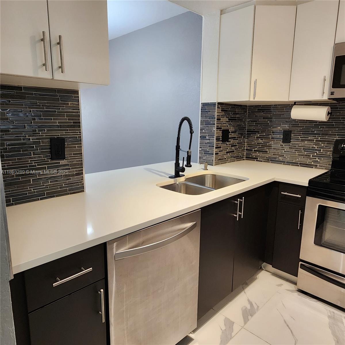 2941 Riverside Drive, Unit 102 Coral Springs, FL 33065 - Photo 7 of 37 a kitchen with a sink and cabinets