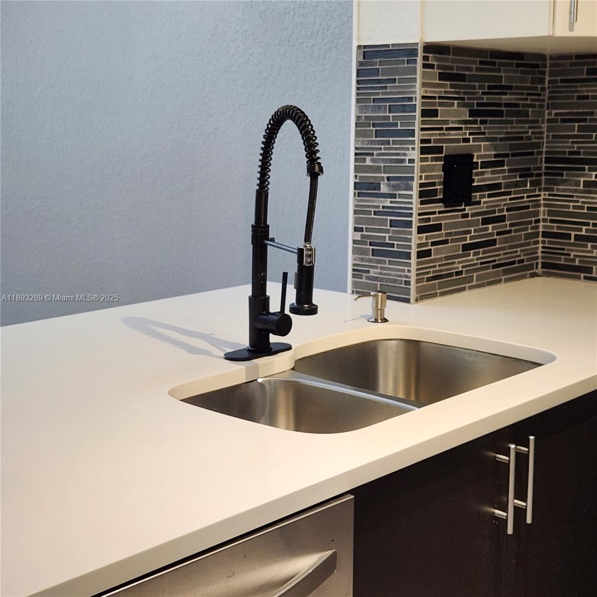 2941 Riverside Drive, Unit 102 Coral Springs, FL 33065 - Photo 8 of 37 a close view of sink and tap