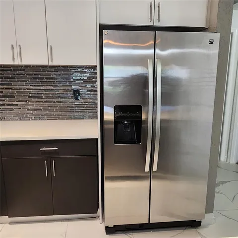 a kitchen with a refrigerator and a counter top