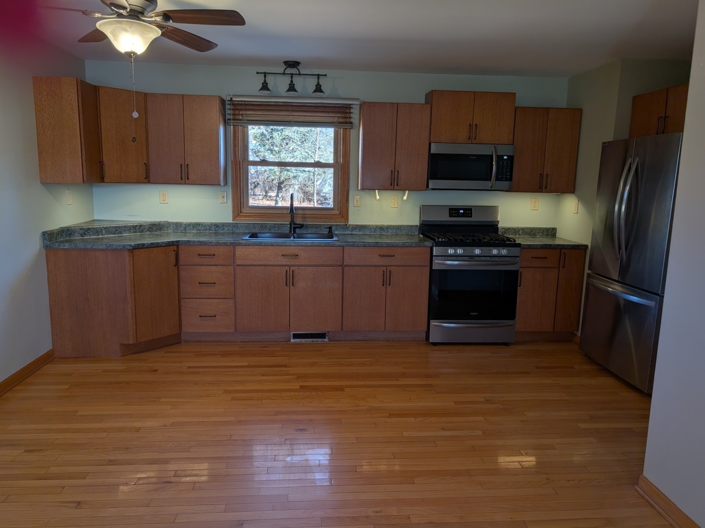 112 Wright Drive Utica, IL 61373 - Photo 4 of 30 a kitchen with stainless steel appliances granite countertop a stove a sink dishwasher a refrigerator and a stove with wooden floor