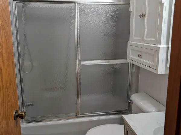 a bathroom with a tub and toilet