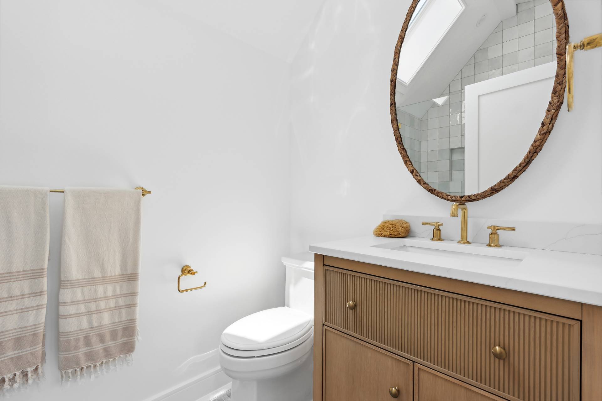 55 Fairview Avenue Montauk, NY 11954 - Photo 12 of 22 a bathroom with a sink a toilet and a mirror