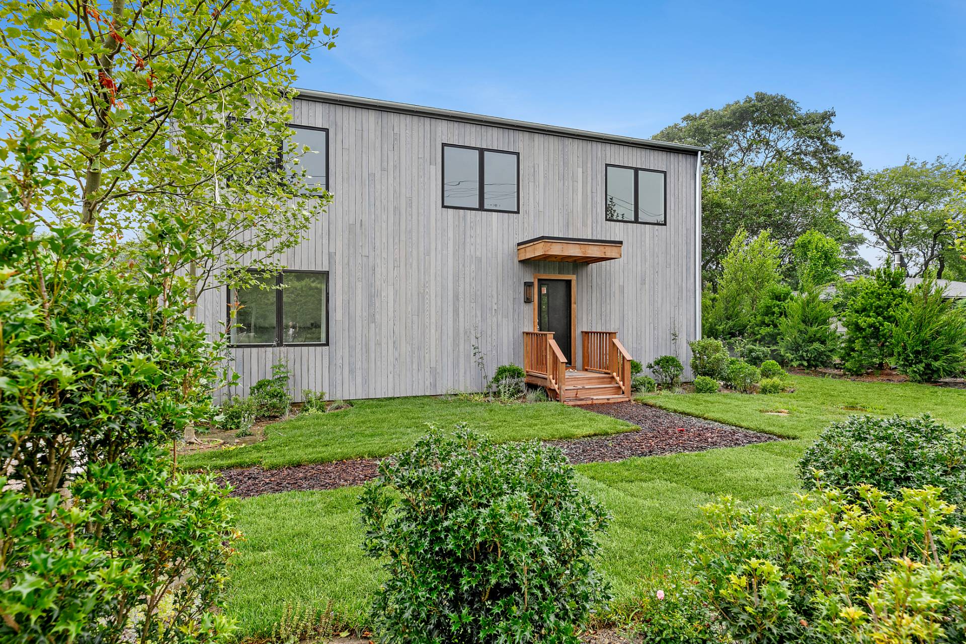 55 Fairview Avenue Montauk, NY 11954 - Photo 18 of 22 a view of a backyard with table and a chairs