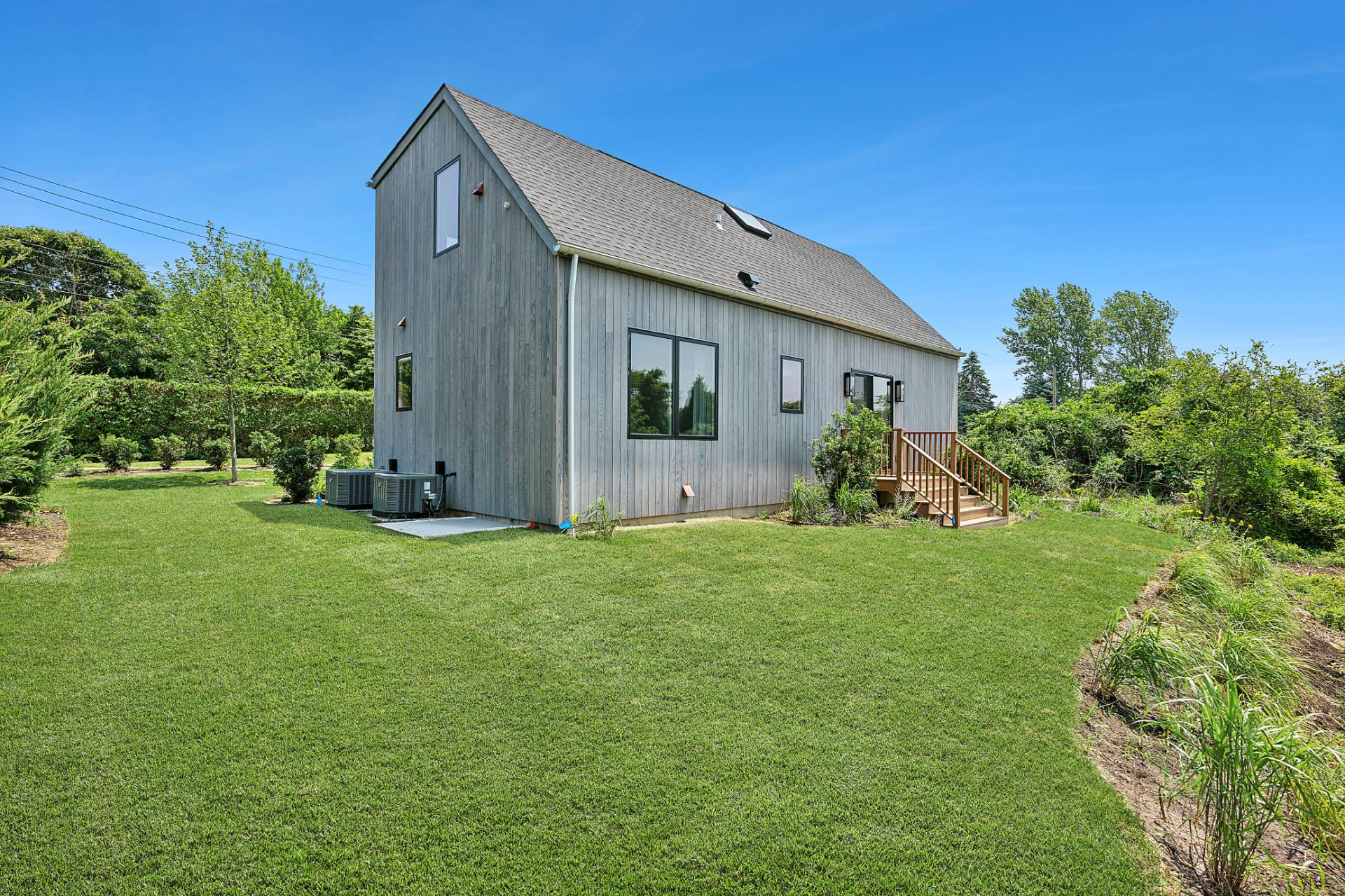 55 Fairview Avenue Montauk, NY 11954 - Photo 19 of 22 a view of a backyard with potted plants and large tree
