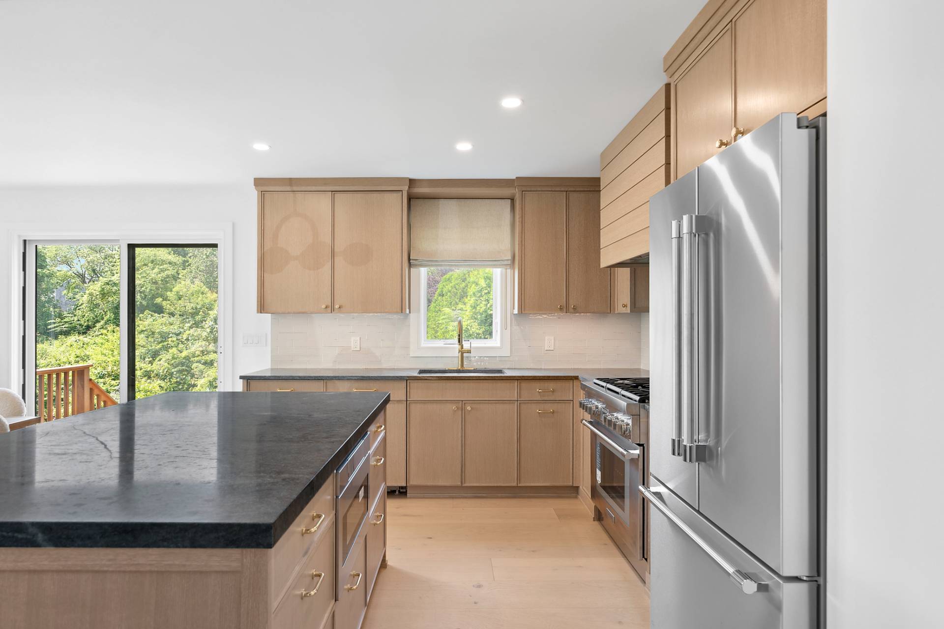 55 Fairview Avenue Montauk, NY 11954 - Photo 8 of 22 a kitchen with stainless steel appliances granite countertop a sink a stove and a refrigerator