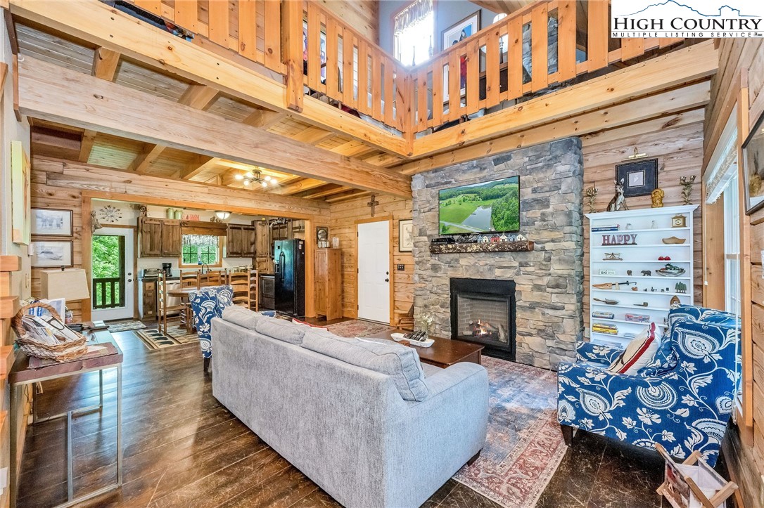 218 Cherokee Circle Jefferson, NC 28640 - Photo 11 of 50 a living room with furniture a fireplace and a table