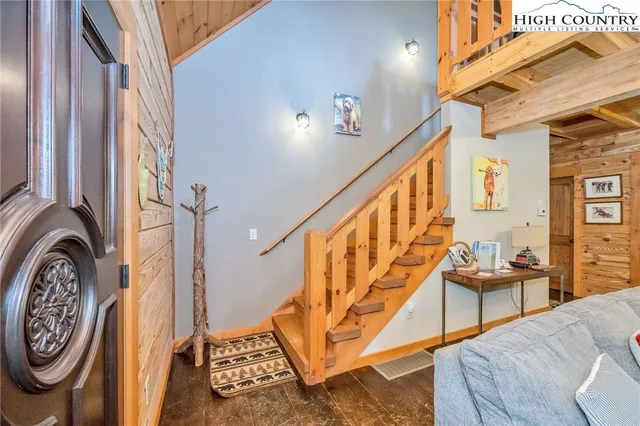 a living room with furniture a fireplace a flat screen tv and next to a wall