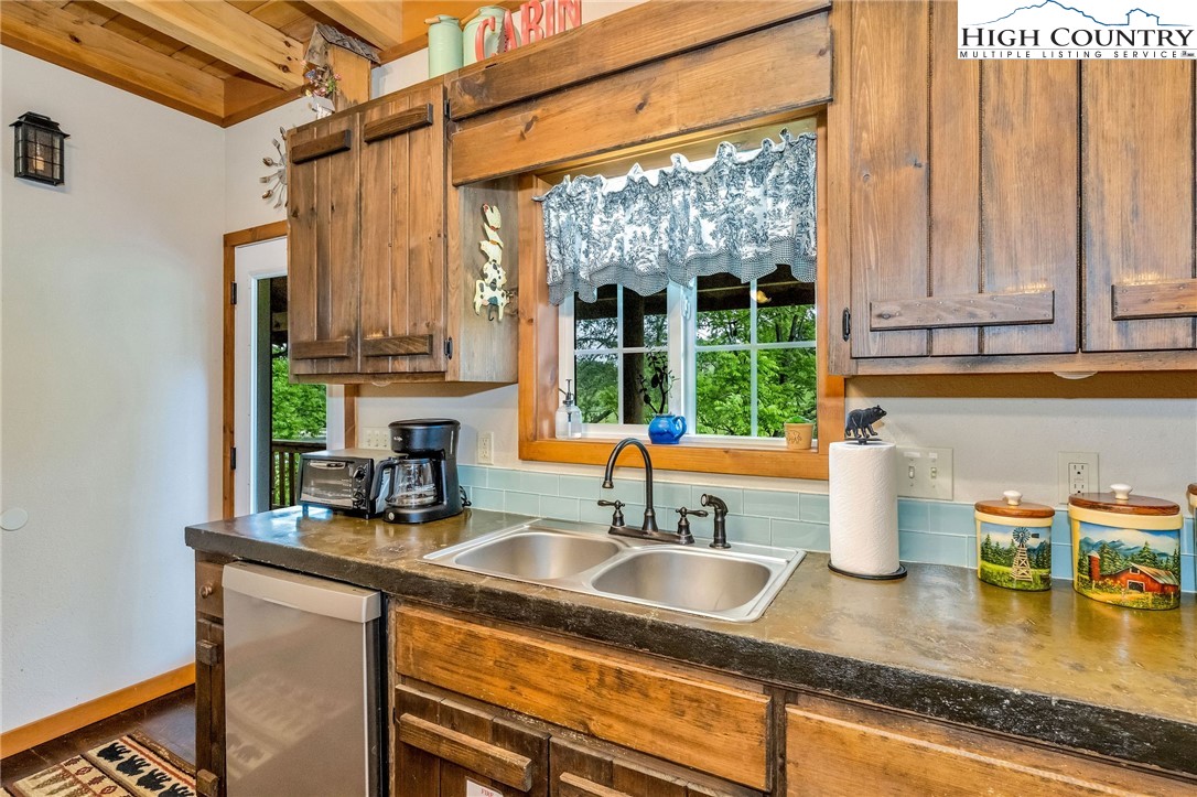 218 Cherokee Circle Jefferson, NC 28640 - Photo 20 of 50 a kitchen with a sink a counter top space and cabinets