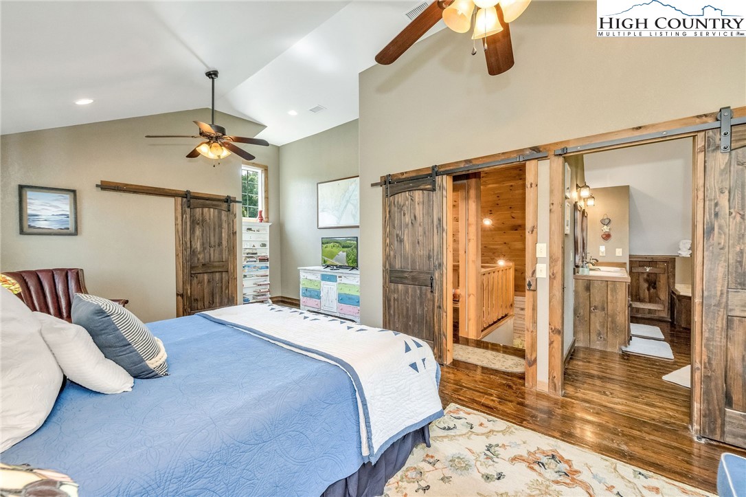 218 Cherokee Circle Jefferson, NC 28640 - Photo 32 of 50 a bedroom with a large bed and a chandelier