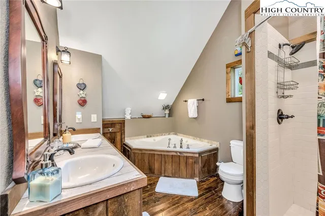 a living room with furniture and a refrigerator