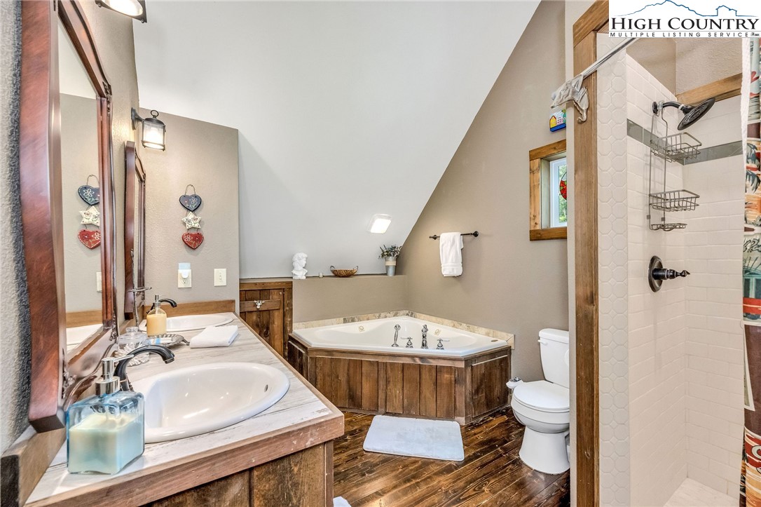 218 Cherokee Circle Jefferson, NC 28640 - Photo 33 of 50 a bathroom with a double vanity sink mirror and toilet