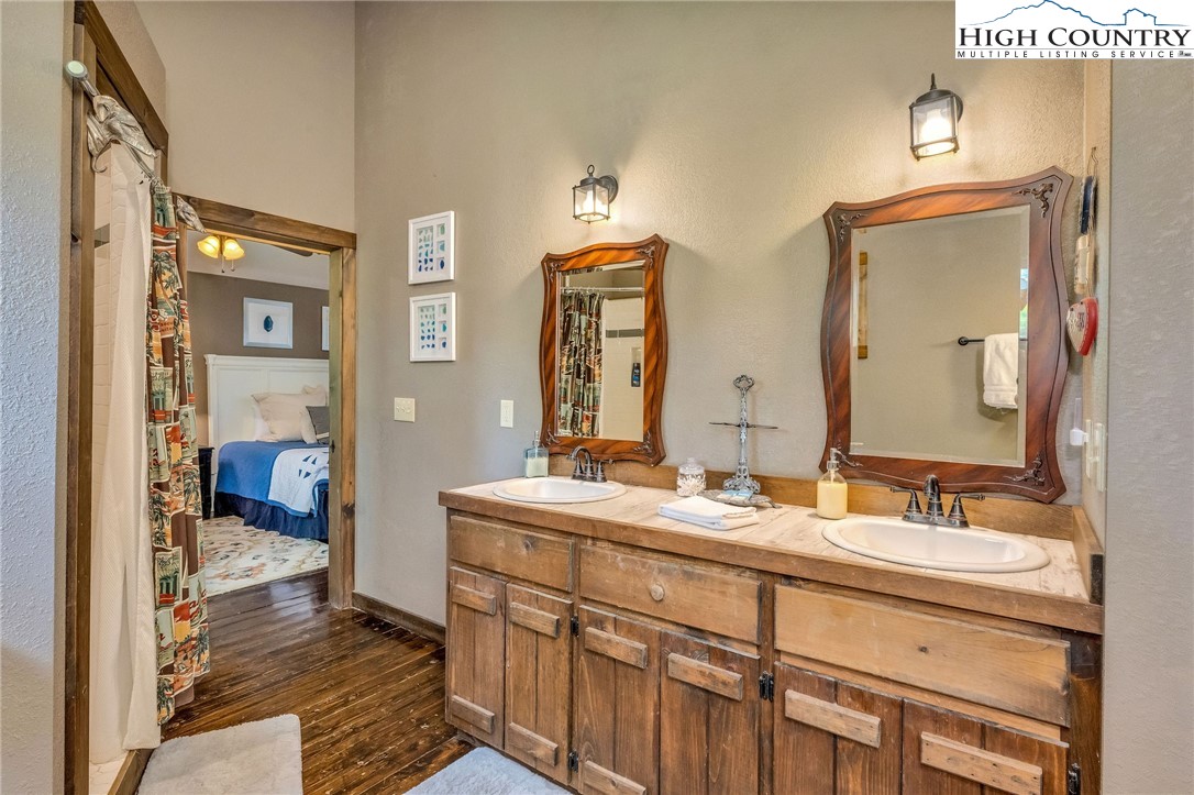 218 Cherokee Circle Jefferson, NC 28640 - Photo 34 of 50 a bathroom with double vanity sinks and a mirror