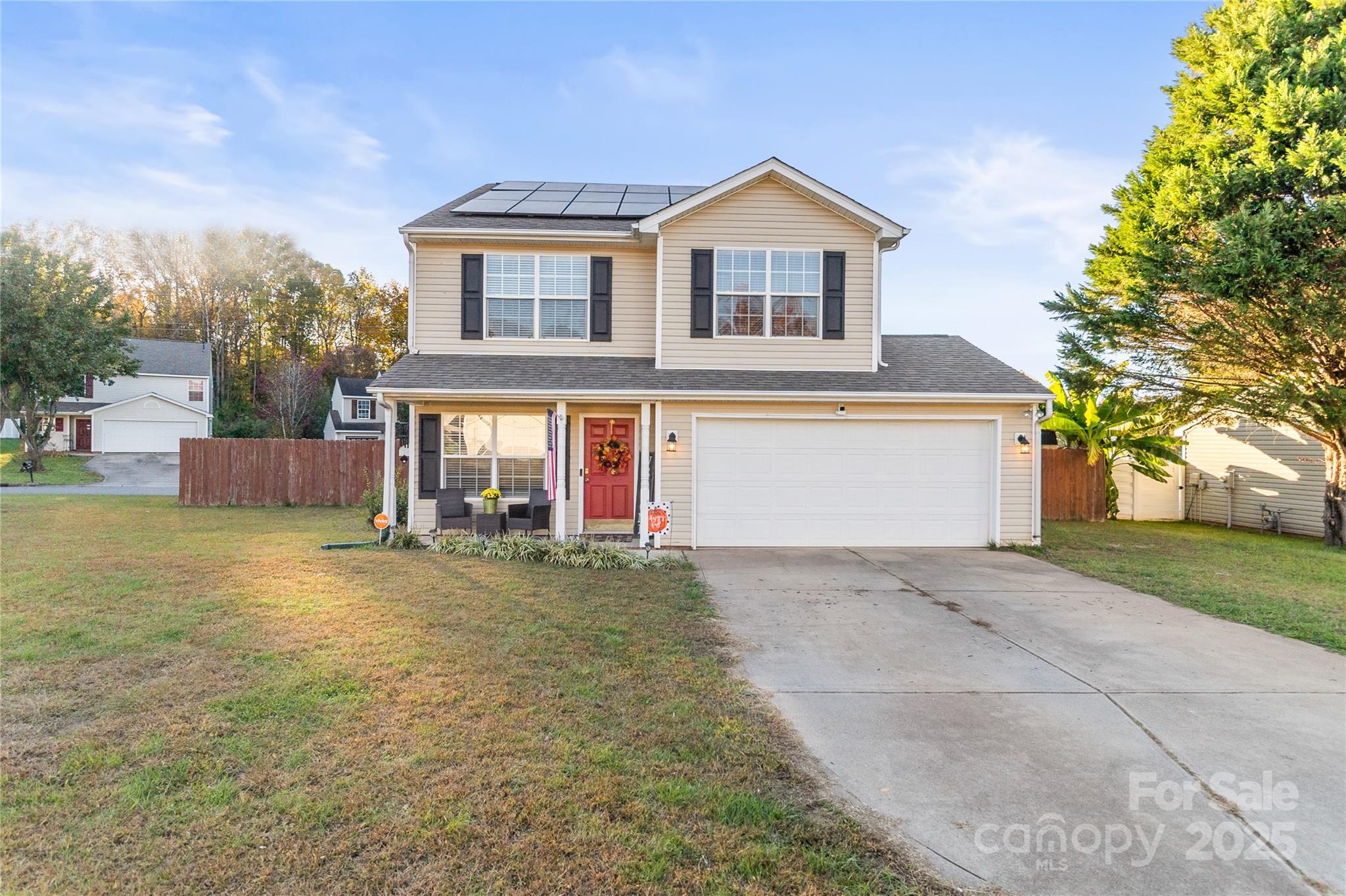 a front view of house with yard and trees