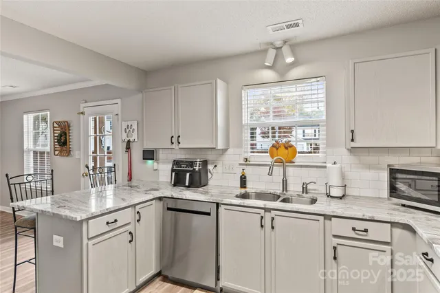 a kitchen with a sink stove and cabinets