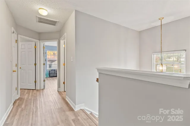 a view of hallway with wooden floor