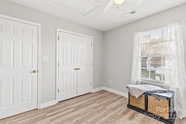 a view of a room with wooden floor and windows