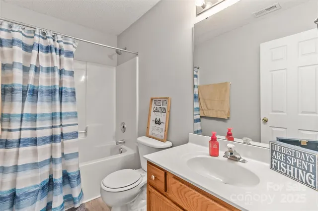 a bathroom with a sink toilet tub and shower