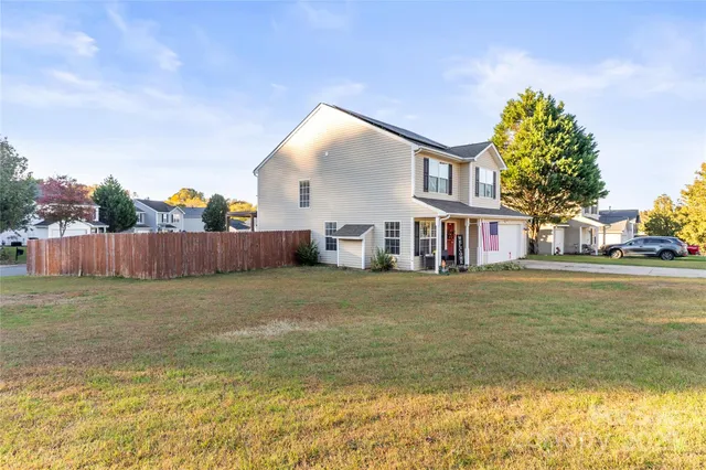 a front view of house with yard and swimming pool