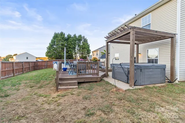 a view of a house with backyard and sitting area