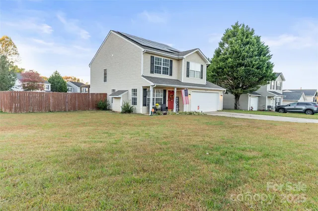 a house view with swimming pool in front of it