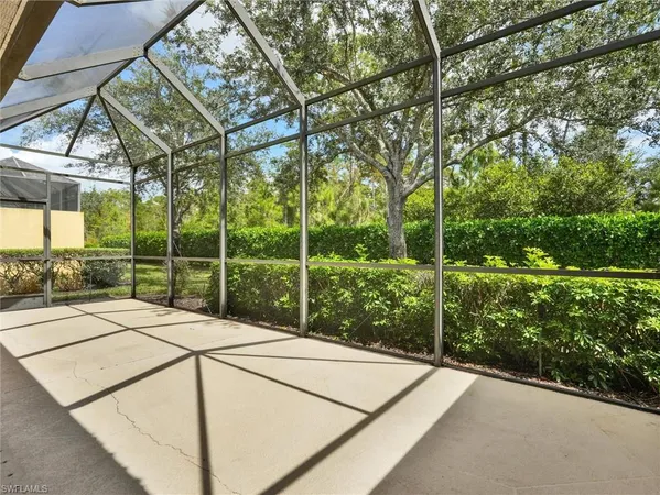 a view of a house with a floor to ceiling window and tree