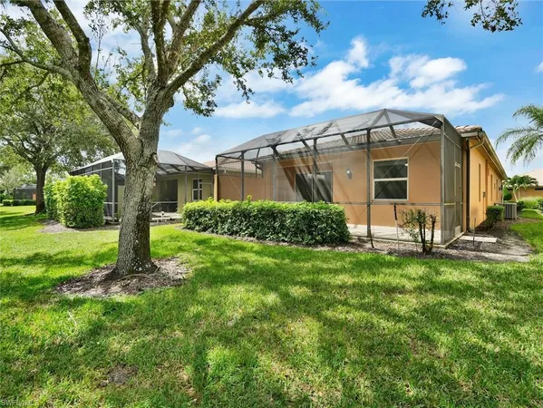 a backyard of a house with table and chairs