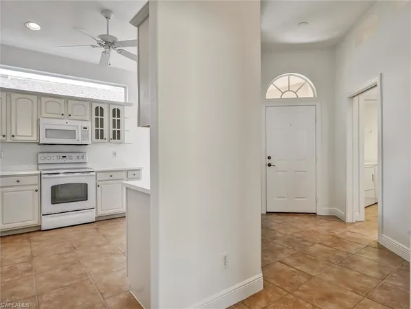 a view of kitchen with sink and refrigerator