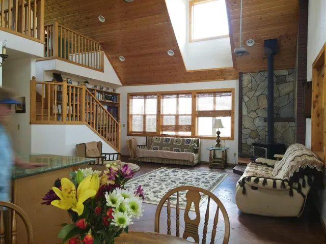 a view of a livingroom with furniture and staircase